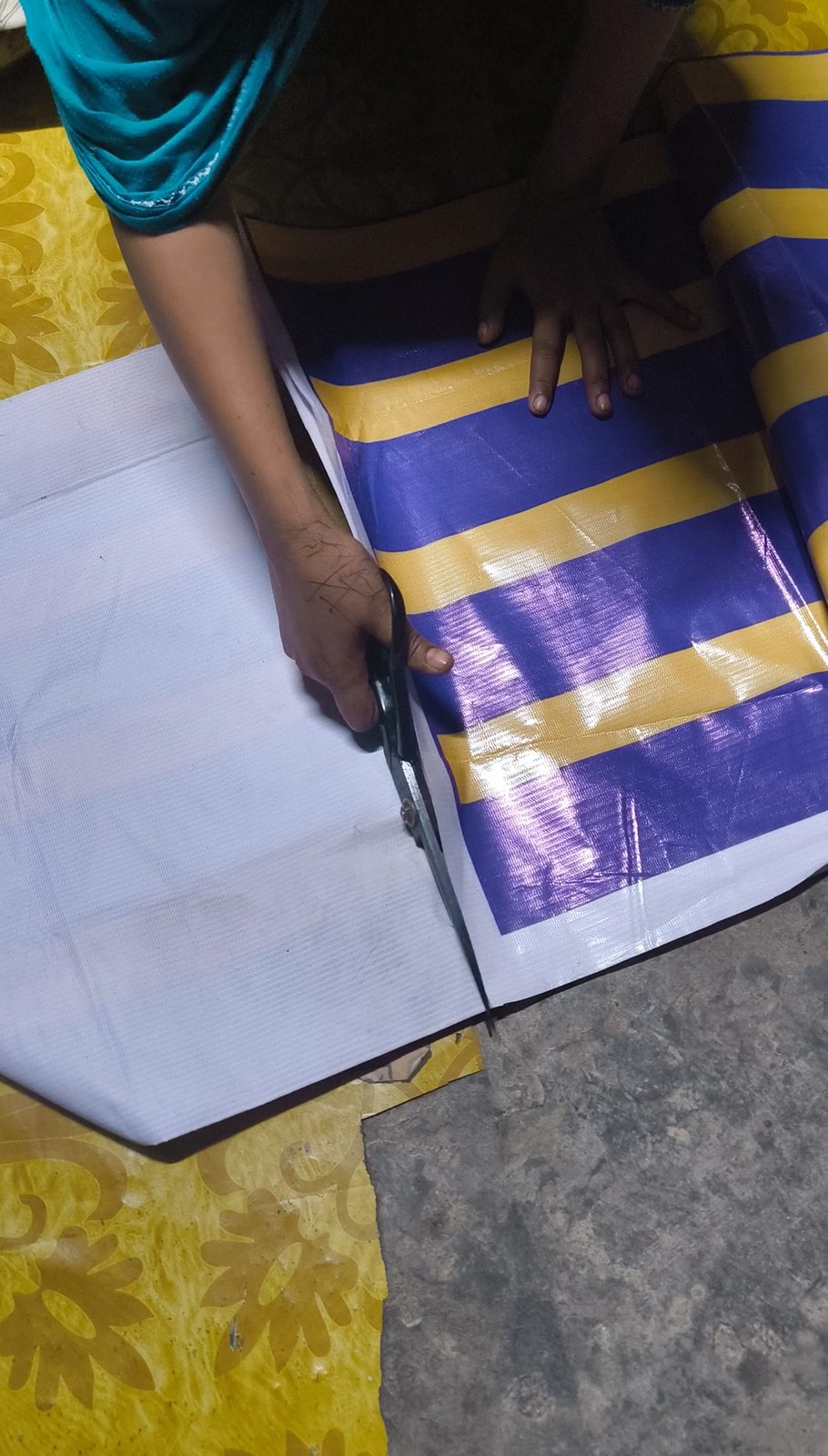 Scissors cutting a straight edge through a rescued banner